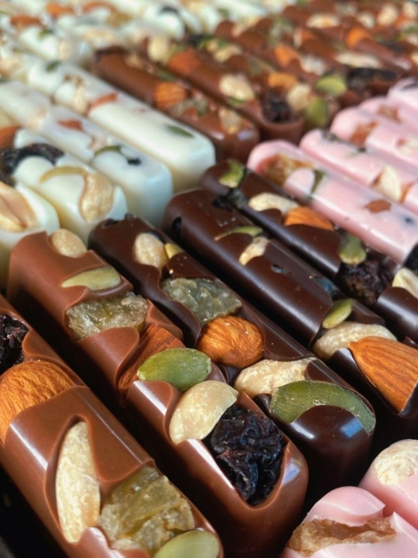 Handcrafted chocolate bars topped with almonds, cashews and dried fruit