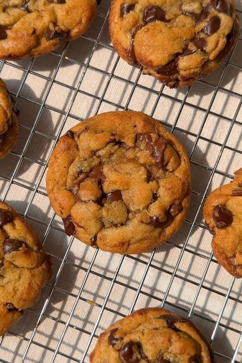 Freshly baked chocolate chunk cookies cooling on a wire rack