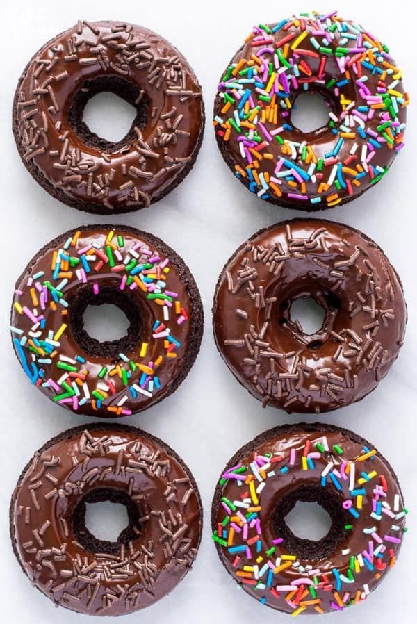 Chocolate glazed donuts finished with chocolate and rainbow sprinkles