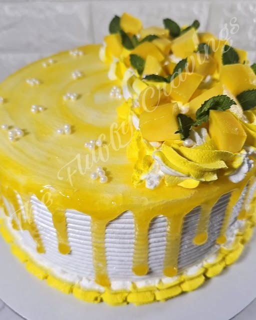 A mango drip cake finished with fresh mango and mint